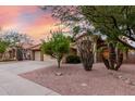 Attractive home showcasing desert landscaping, a tiled roof, and an attached three-car garage at 438 E Vaughn Ave, Gilbert, AZ 85234