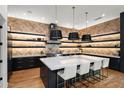 Spacious kitchen with large center island, modern pendant lighting, and custom shelving at 5301 E Paradise Canyon Rd, Paradise Valley, AZ 85253