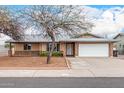 Charming single-story home featuring a two-car garage, brick accents, and a well-maintained front yard at 5401 S Siesta Ln, Tempe, AZ 85283