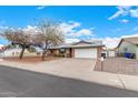 Charming single-story home featuring a two-car garage, brick accents, and a well-maintained front yard at 5401 S Siesta Ln, Tempe, AZ 85283