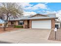 Charming single-story home featuring a two-car garage, brick accents, and a well-maintained front yard at 5401 S Siesta Ln, Tempe, AZ 85283