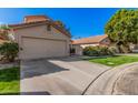 Single-Gathering home featuring a well-maintained lawn and a two-car garage with a long driveway at 73 E Caroline Ln, Tempe, AZ 85284