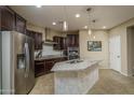 Modern kitchen featuring stainless steel appliances, granite countertops, and custom cabinetry at 9547 W Chama Dr, Peoria, AZ 85383