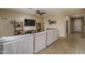 Comfortable living area featuring tan walls, tiled entryway, and access to other rooms at 9547 W Chama Dr, Peoria, AZ 85383