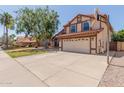 Beautiful home with a red tile roof and an extended driveway with a basketball hoop at 956 N 58Th St, Mesa, AZ 85205