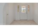 Inviting entryway featuring a decorative glass front door and neutral tile flooring at 962 E Greenway St, Mesa, AZ 85203