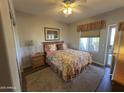 Comfortable bedroom featuring a floral-patterned bed, neutral walls, and natural light creating a relaxing retreat at 9750 N Monterey Dr # 67, Fountain Hills, AZ 85268