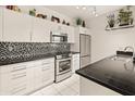 Well-lit kitchen with white cabinets, stainless steel appliances, and granite countertops at 11333 N 92Nd St # 1021, Scottsdale, AZ 85260