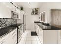 Bright kitchen featuring white cabinets, granite countertops, and stainless steel appliances at 11333 N 92Nd St # 1021, Scottsdale, AZ 85260