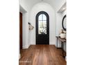 Elegant entryway featuring a black door with glass and a wooden floor at 18886 N 101St Way, Scottsdale, AZ 85255