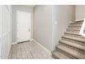 Welcoming foyer with tiled floor, neutral walls, and a staircase leading to the upper level at 25339 N 19Th Ln, Phoenix, AZ 85085