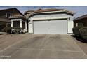 Spacious driveway leading up to the attached two-car garage in front of house at 25798 W Miami St, Buckeye, AZ 85326