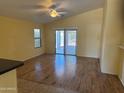 Well-lit living room with wood floors and sliding glass doors to the backyard at 25798 W Miami St, Buckeye, AZ 85326