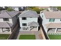 Aerial view of backyard with synthetic grass lawn, patio furniture, and privacy fence at 2855 E Tina Dr, Phoenix, AZ 85050