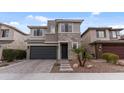 A modern two-story home with a stone facade, well-manicured landscaping, and a two-car garage at 2855 E Tina Dr, Phoenix, AZ 85050