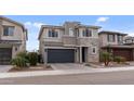 A modern two-story home with a stone facade, well-manicured landscaping, and a two-car garage at 2855 E Tina Dr, Phoenix, AZ 85050