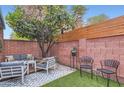 Private outdoor patio with a vibrant orange tree and comfortable seating area at 3002 N 32Nd St # 13, Phoenix, AZ 85018