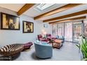 Bright living room with skylight, exposed beams, and access to the patio at 3002 N 32Nd St # 13, Phoenix, AZ 85018