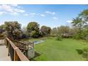 Expansive backyard view from a wooden deck with a pool and lush green landscape, perfect for outdoor activities at 3264 E Vineyard Rd, Phoenix, AZ 85042