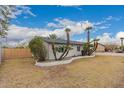 Corner lot home with a well manicured lawn and landscaped with trimmed palm trees at 3407 E Hubbell St, Phoenix, AZ 85008