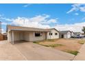Spacious single-story home with a covered carport, modern siding, and a neatly paved driveway at 3626 W Elm St, Phoenix, AZ 85019