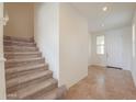 Spacious entryway showcasing a staircase and a bright front door at 40262 W Molly Ln # 138, Maricopa, AZ 85138