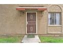 Up-close front door of a cozy home with a secure screen door and covered awning at 4258 N 68Th Dr, Phoenix, AZ 85033