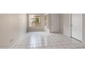 Sunlit living room with tile floors, and a bright view through a window at 4608 W Maryland Ave # 122, Glendale, AZ 85301