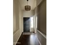 Inviting foyer with hardwood floors, stylish light fixture, and neutral wall paint at 4751 E White Aster St, Phoenix, AZ 85044