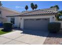 Attached two-car garage showcasing a clean driveway and manicured landscaping at 4751 E White Aster St, Phoenix, AZ 85044