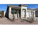 Inviting single-story home showcasing a covered porch, stone accents, and drought-tolerant desert landscaping at 4919 S 106Th Ave, Tolleson, AZ 85353