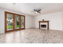 Bright living room featuring a fireplace, tile floors, and sliding glass doors at 5332 W Linda Ln, Chandler, AZ 85226