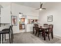 Dining room features dark wood table, four chairs, and open access to kitchen at 5518 E Lindstrom Ln # 2038, Mesa, AZ 85215