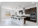 Modern kitchen boasting a center island, stainless steel appliances and dark wood cabinets at 5710 N 84Th Ave, Glendale, AZ 85305