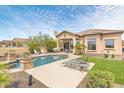 Backyard oasis featuring a pristine pool, lush green grass, and comfortable lounge chairs at 8359 E Ingram Cir, Mesa, AZ 85207