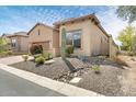 A tan stucco home with desert landscaping including a cactus and rock drainage at 8359 E Ingram Cir, Mesa, AZ 85207