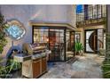 Private patio with custom stonework, a built-in grill, and access to the living room at 8369 E Del Camino Dr, Scottsdale, AZ 85258