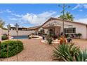 Expansive backyard featuring a pool, patio with outdoor seating, and mature desert plants, ideal for entertaining at 8568 W Purdue Ave, Peoria, AZ 85345