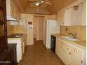 Functional kitchen featuring ample cabinet space and a refrigerator at 10319 W Willie Low Cir, Sun City, AZ 85351