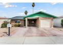 Single-story brick home with a covered parking area, a garage, and a desert-landscaped front yard at 10440 W Devonshire Ave, Phoenix, AZ 85037