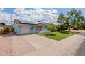Front exterior view of a charming home with a paved driveway and well-maintained lawn at 12607 N 25Th Ave, Phoenix, AZ 85029
