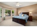 Serene main bedroom with large windows, plush carpet, and golf course views at 15560 W Clear Canyon Dr, Surprise, AZ 85374