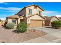 Stylish two-story home with desert landscaping, a two-car garage, and a well-maintained facade at 1563 S 227Th Ave, Buckeye, AZ 85326