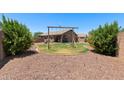 Spacious backyard featuring a swing set and beautiful landscaping, creating a perfect outdoor retreat at 16653 N 169Th Ave, Surprise, AZ 85388