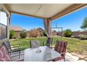 Covered patio offers a relaxing outdoor living space, perfect for entertaining and enjoying the manicured backyard at 16653 N 169Th Ave, Surprise, AZ 85388