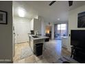 Bright, open kitchen with stainless steel appliances, a breakfast bar, and sliding glass doors at 1701 E Colter St # 138, Phoenix, AZ 85016