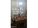 Cozy dining area with a wooden table, chairs, and a window view, perfect for meals at 2058 S Walla Walla Cir, Apache Junction, AZ 85119