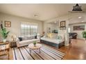 Cozy living room featuring bright natural light, neutral paint, couches, and stylish striped rug at 23217 N 22Nd Pl, Phoenix, AZ 85024