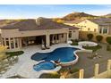 Expansive backyard featuring a pool, spa, fire pit, and covered patio for outdoor entertaining at 2333 N 87Th Pl, Mesa, AZ 85207