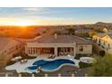 Gorgeous backyard with a pool, spa, outdoor kitchen, and lush landscaping at 2333 N 87Th Pl, Mesa, AZ 85207